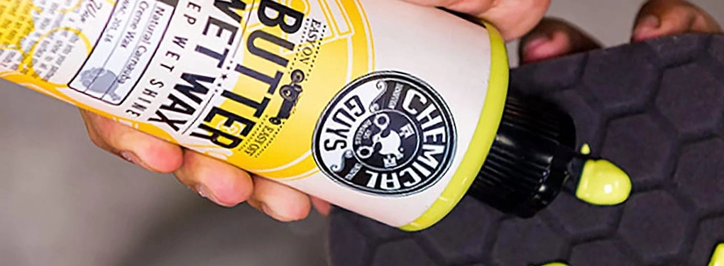 Close-up of car wax on a foam applicator pad ready for use during car detailing