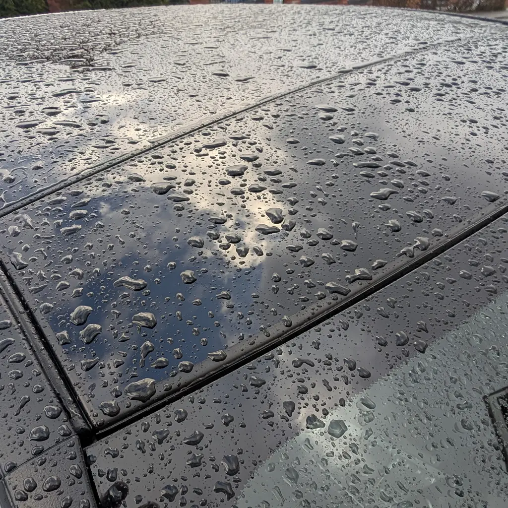 Chemical Guys Heavy Duty Water Spot Remover bottle during glass cleaning