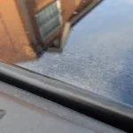 Chemical Guys Heavy Duty Water Spot Remover bottle during glass cleaning