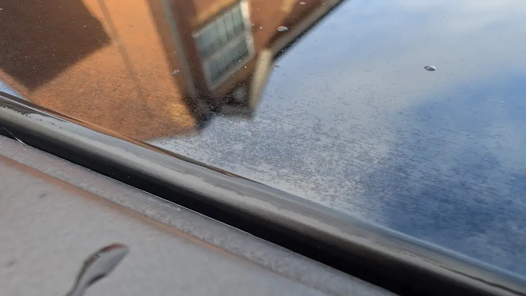 Chemical Guys Heavy Duty Water Spot Remover bottle during glass cleaning