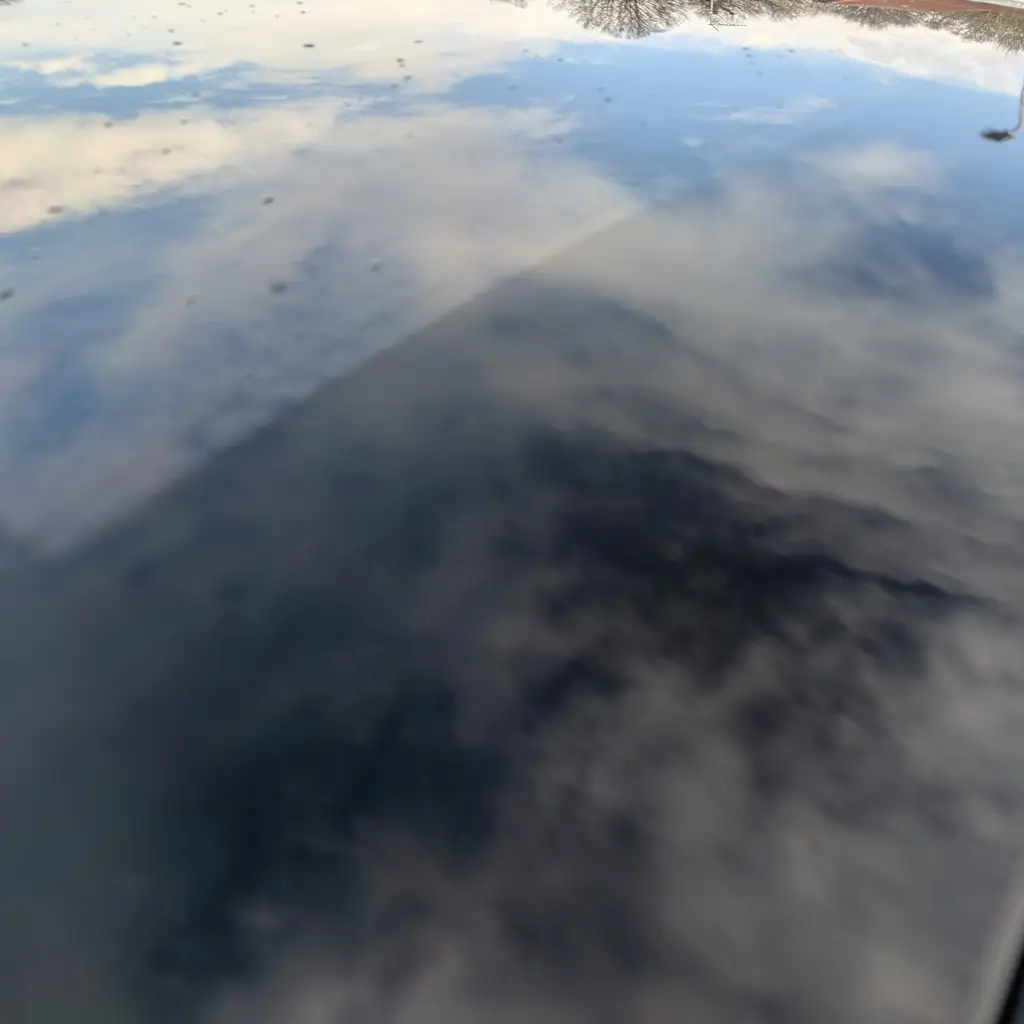 Chemical Guys Heavy Duty Water Spot Remover bottle during glass cleaning